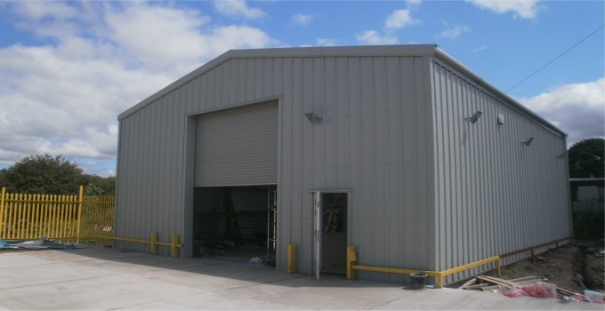 Building used as an industrial unit with steel roller door and side access