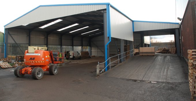 Wide entrance storage and loading bay showing space available with a steel-framed building